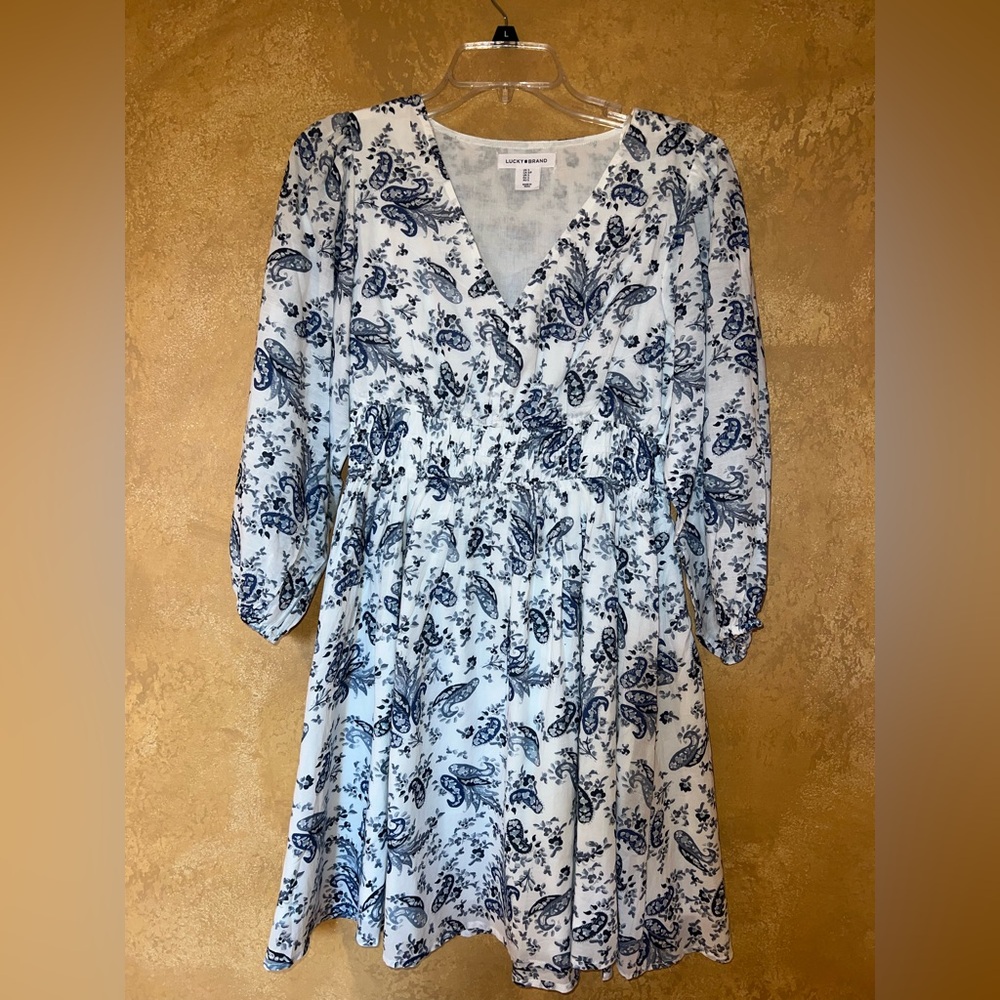 White long sleeve dress with blue pattern.